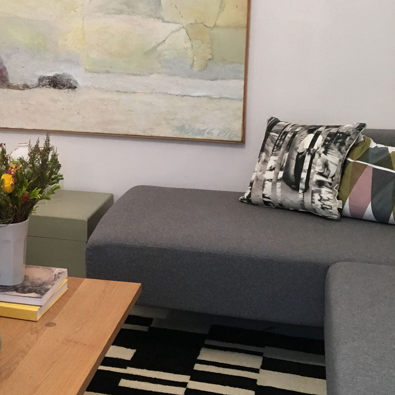 Between Certainty and Oblivion linen cushion by Joel Weaver for The Monkey Puzzle Tree on grey sofa