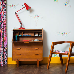 mid century home office featuring scant style wallpaper with birds and leaves